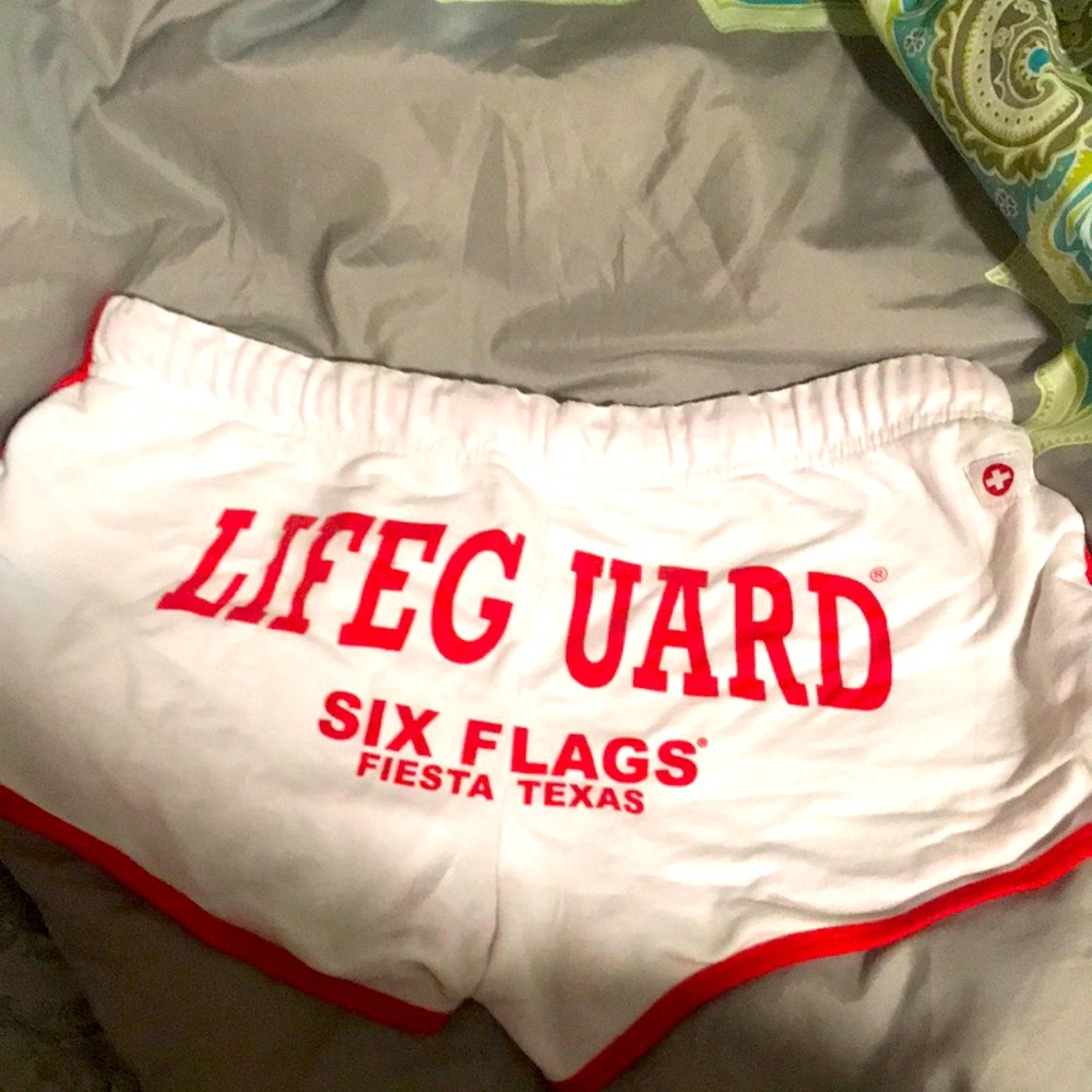Like new red and white Fiesta Texas life guard shorts